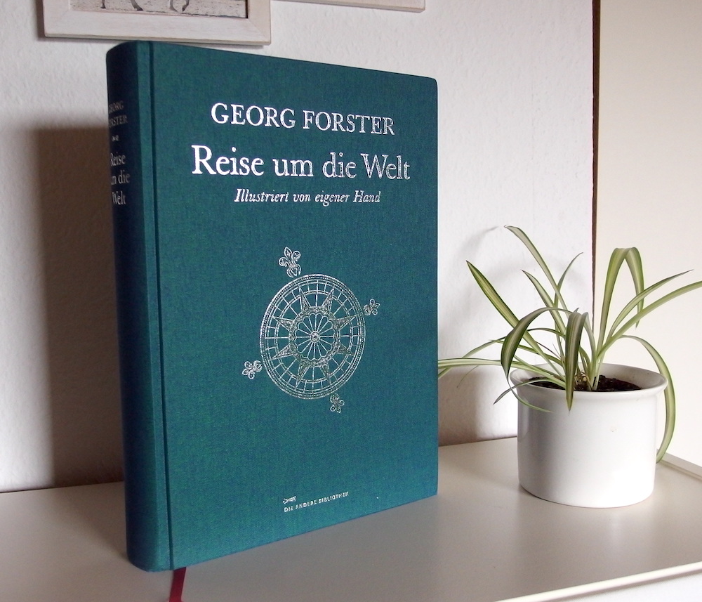 Das Buch "Reise um die Welt" ist in dunkelgrünes Leinen gebunden und hat den Titel und eine Windrose silbern eingeprägt.